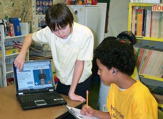 Photograph of two boys using a Signing Science dictionary